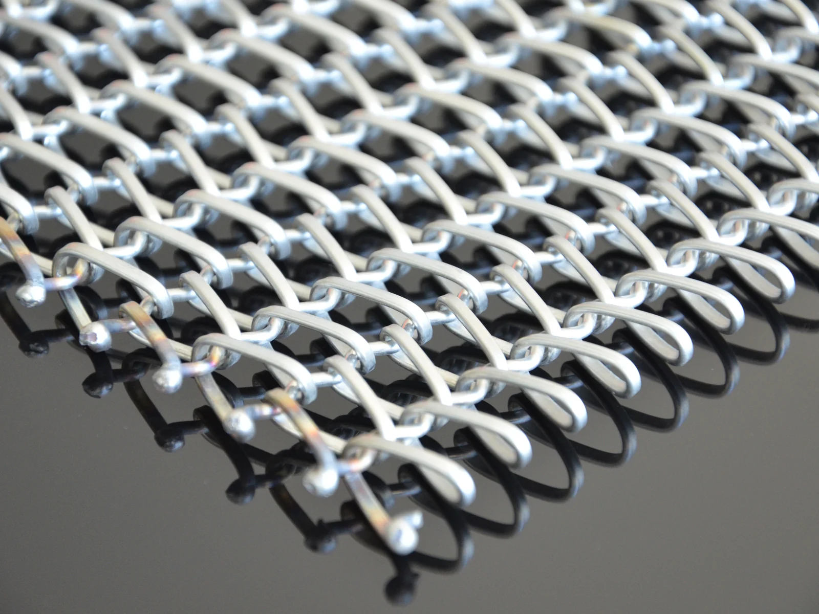 Round wire spirals joined into a repeating mesh surface