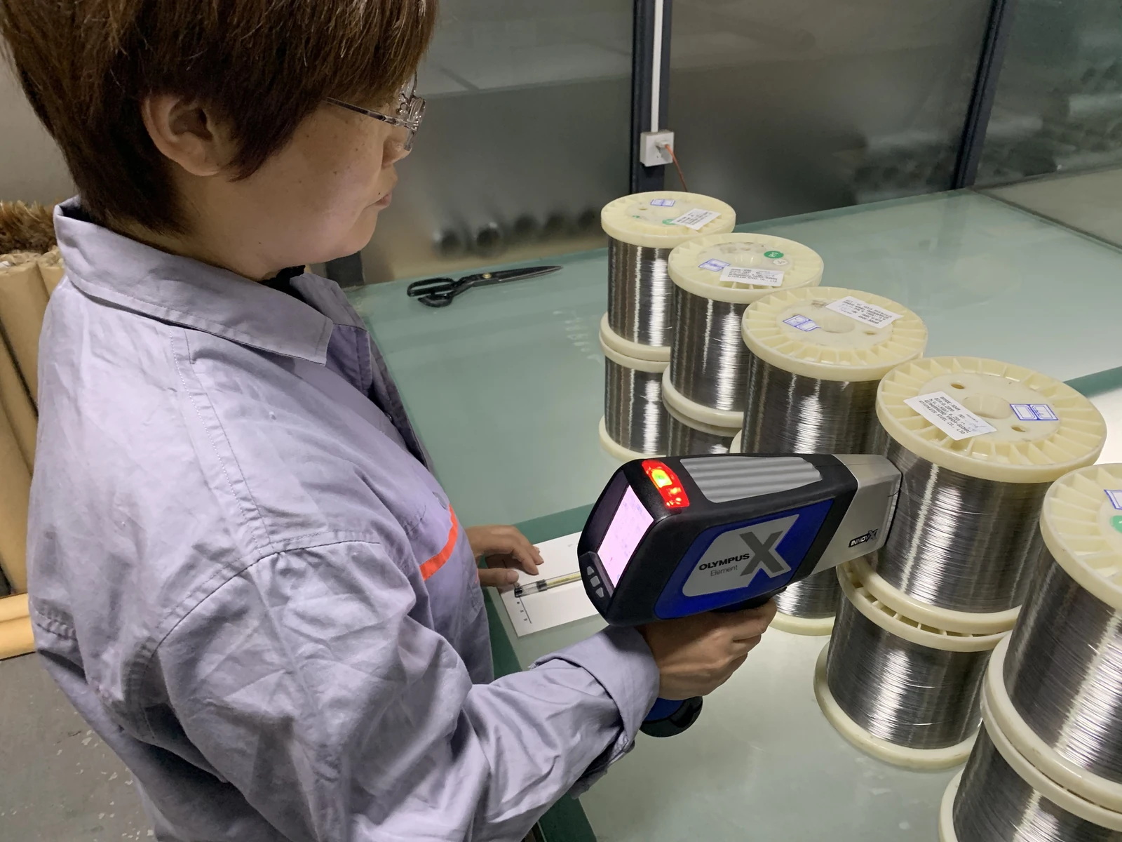 amber quality wire material inspection 01 AMBER inspector checking wire material with a handheld instrument