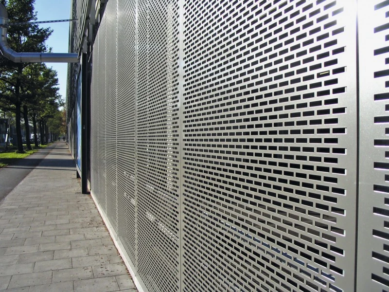 Rectangular perforated panels screening an exterior walkway