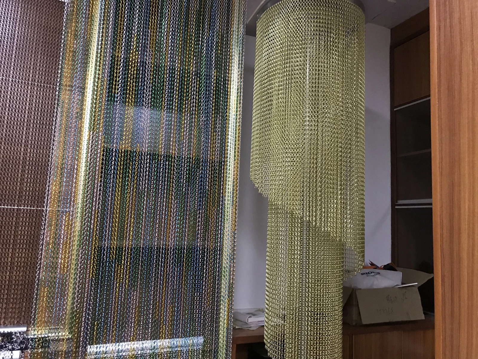 Linked metal chain curtains hanging in several colored strands