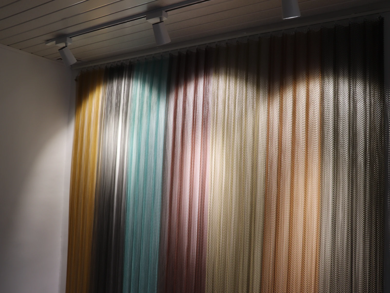 Suspended coil drapery showing a continuous flexible curtain surface