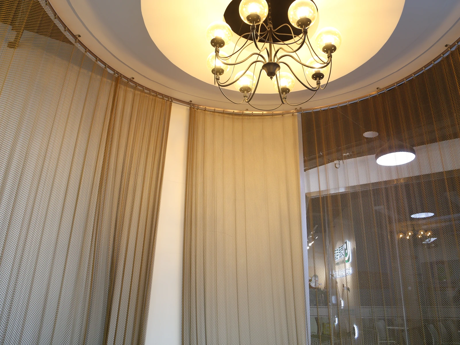 Coil drapery hanging around the perimeter of a circular interior area